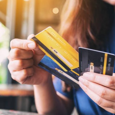 Closeup image of a woman holding and choosing credit card to use